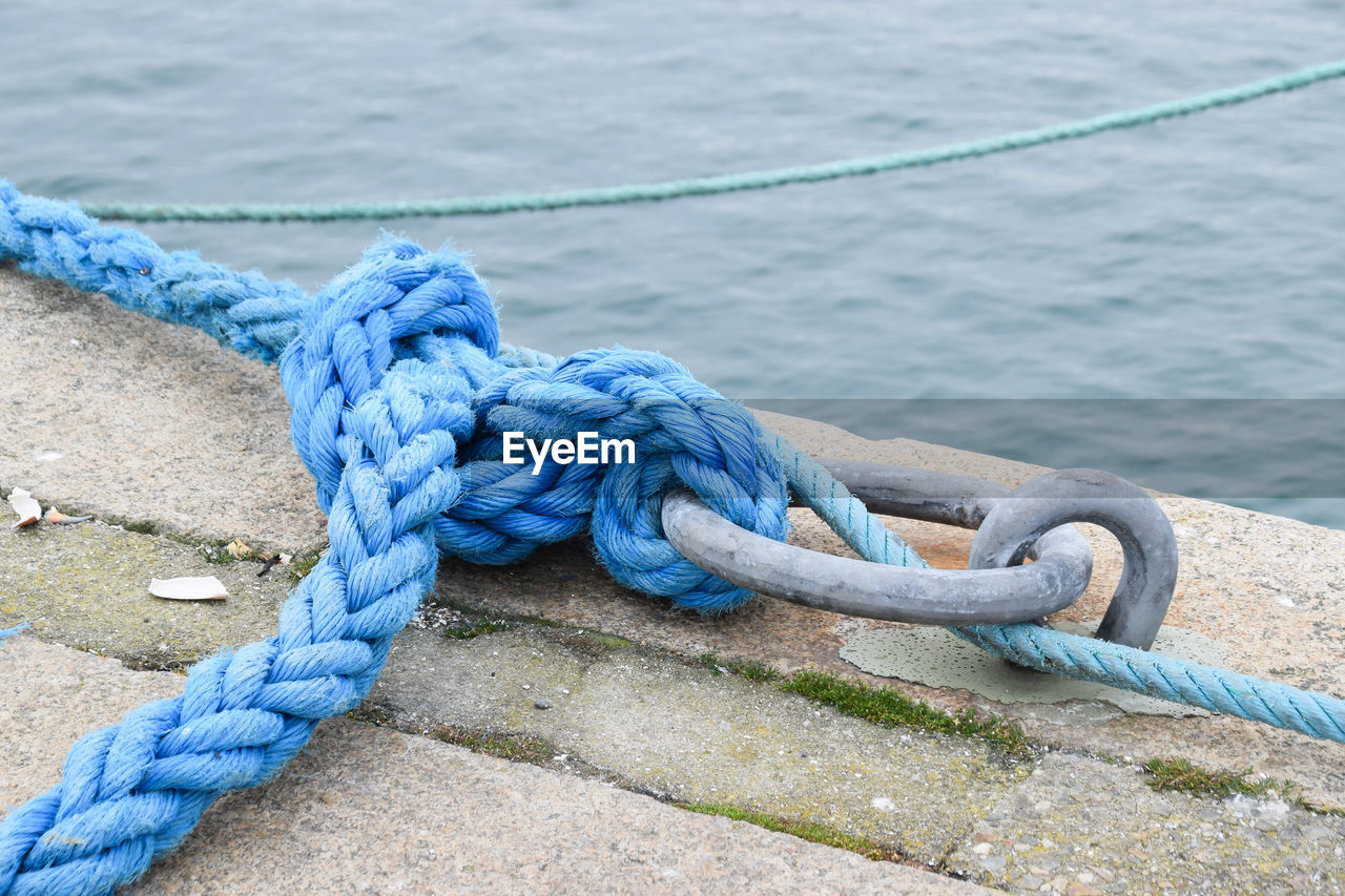 Close-up of rope tied at pier