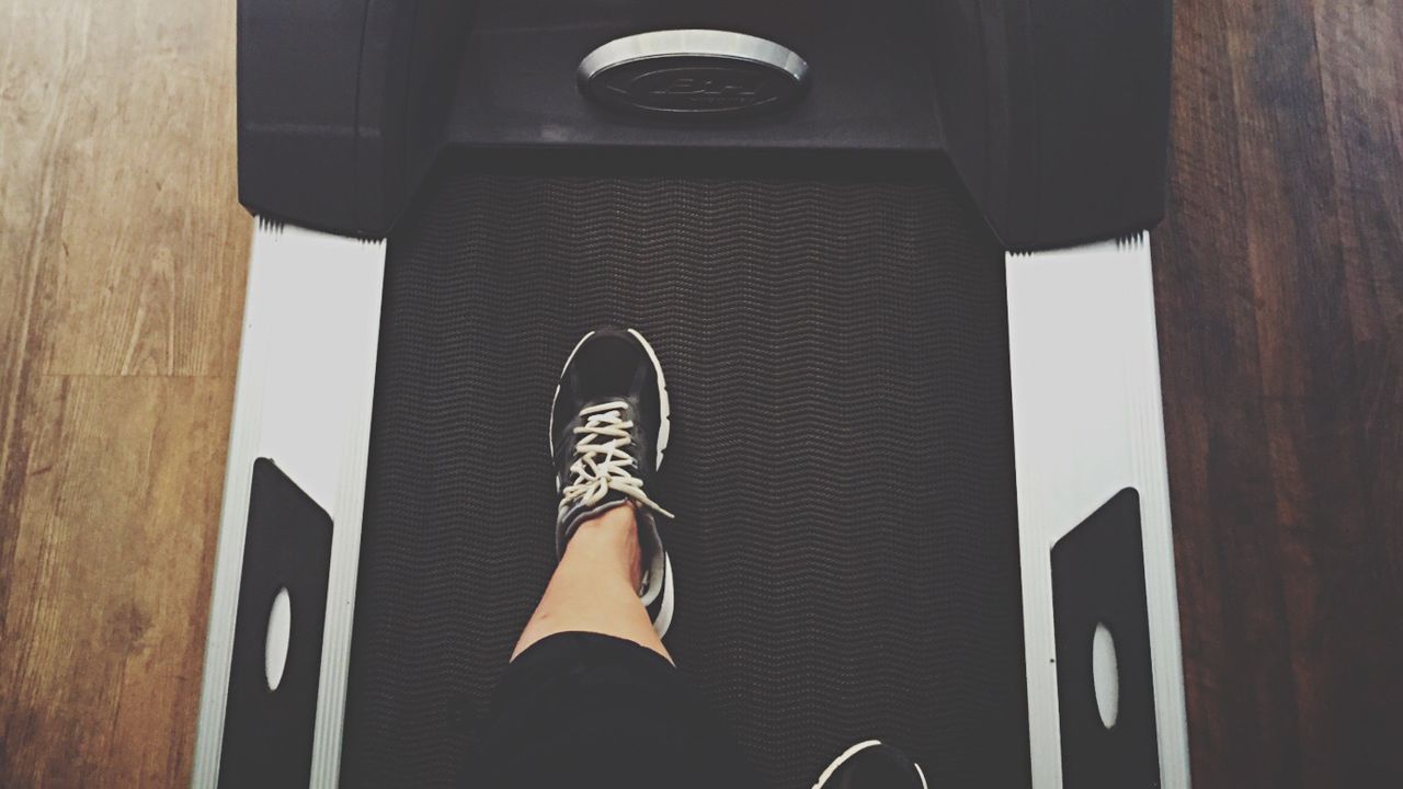 Low section of person on treadmill at gym