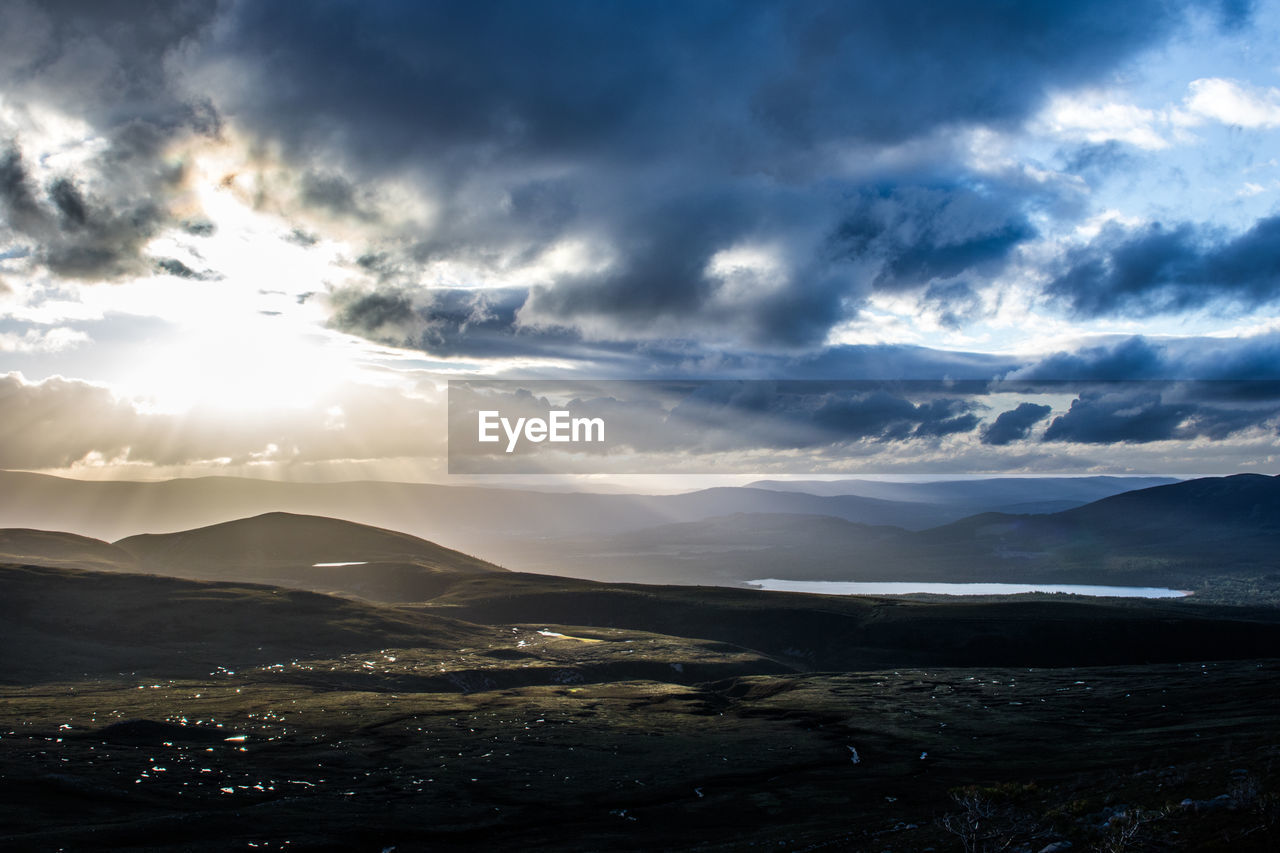 Scenic view of mountains against cloudy sky