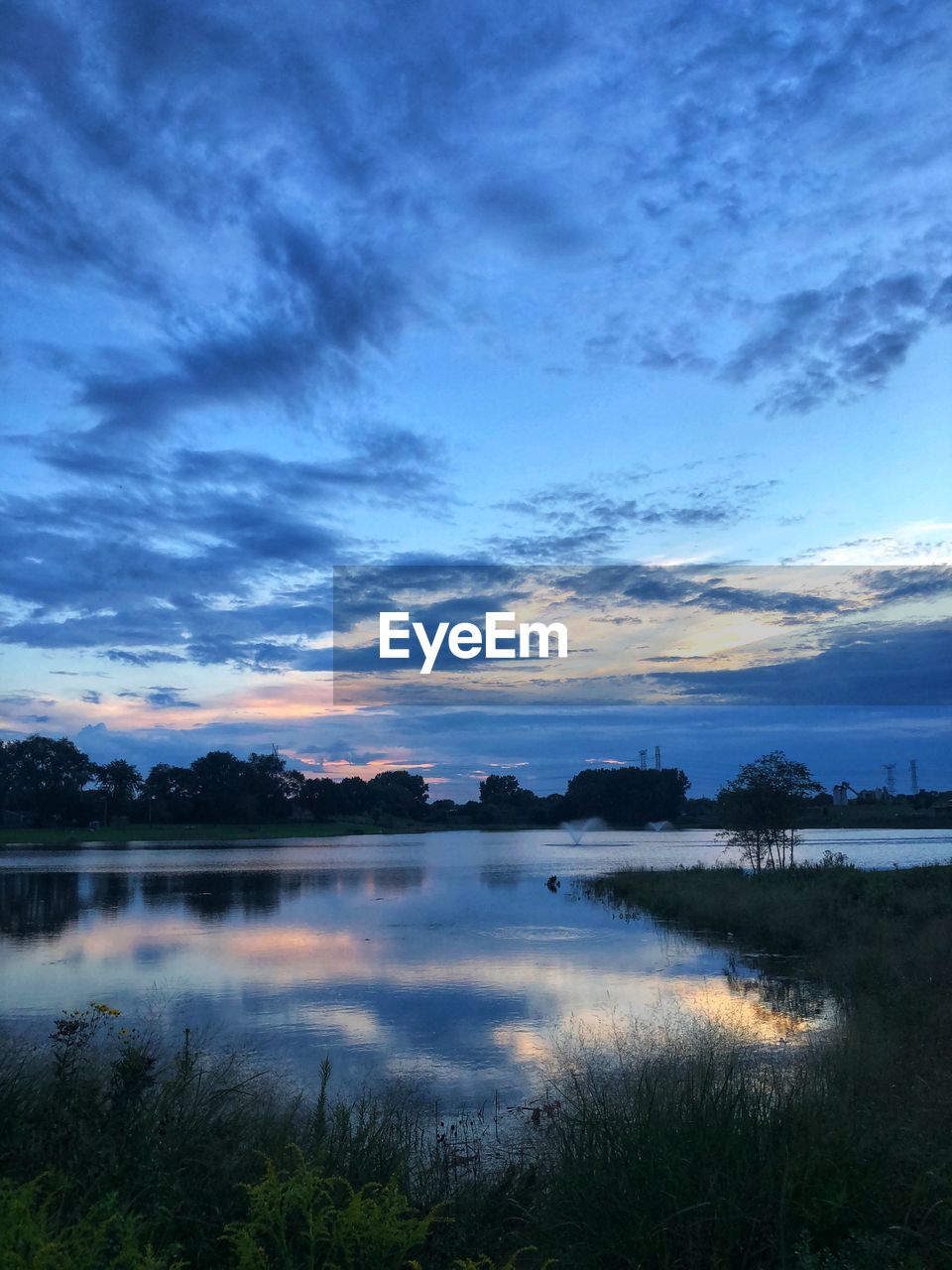 SCENIC VIEW OF LAKE AT SUNSET