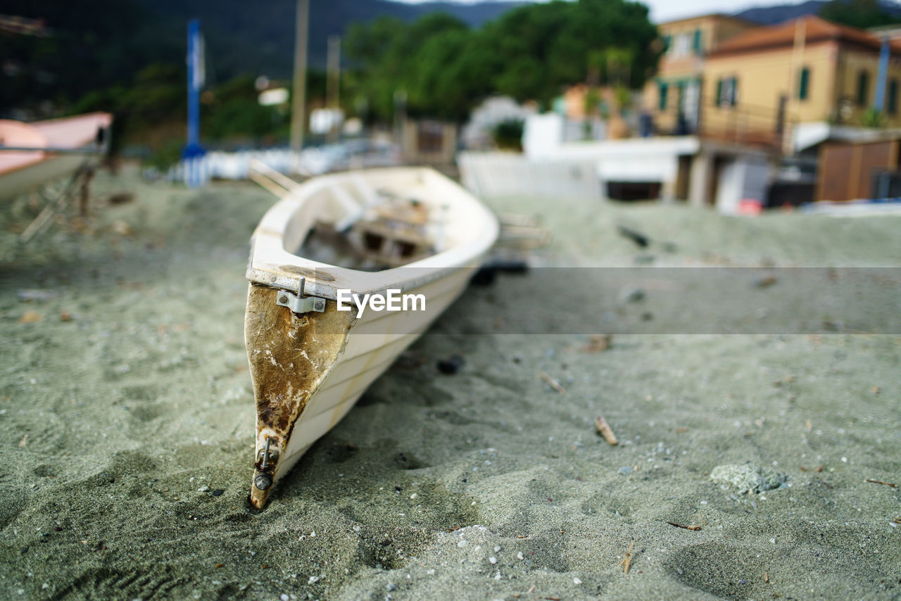 CLOSE-UP OF DAMAGED BOAT ON STREET