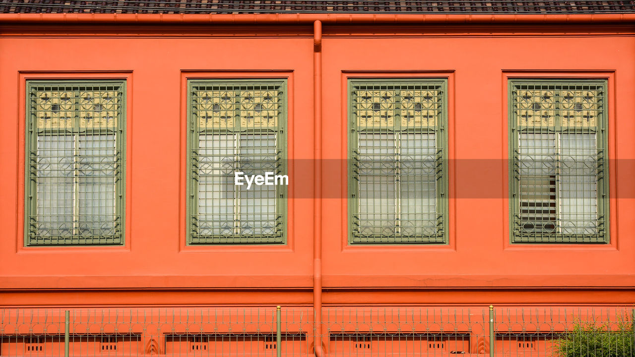 FULL FRAME SHOT OF BUILDING WITH ORANGE WINDOWS