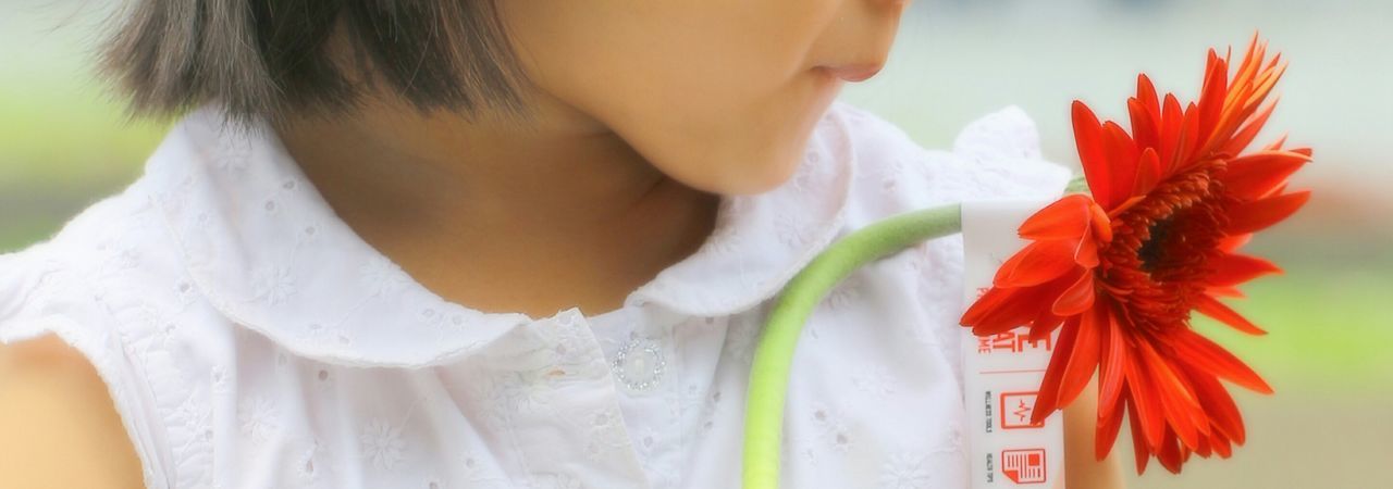 Midsection of girl holding flower