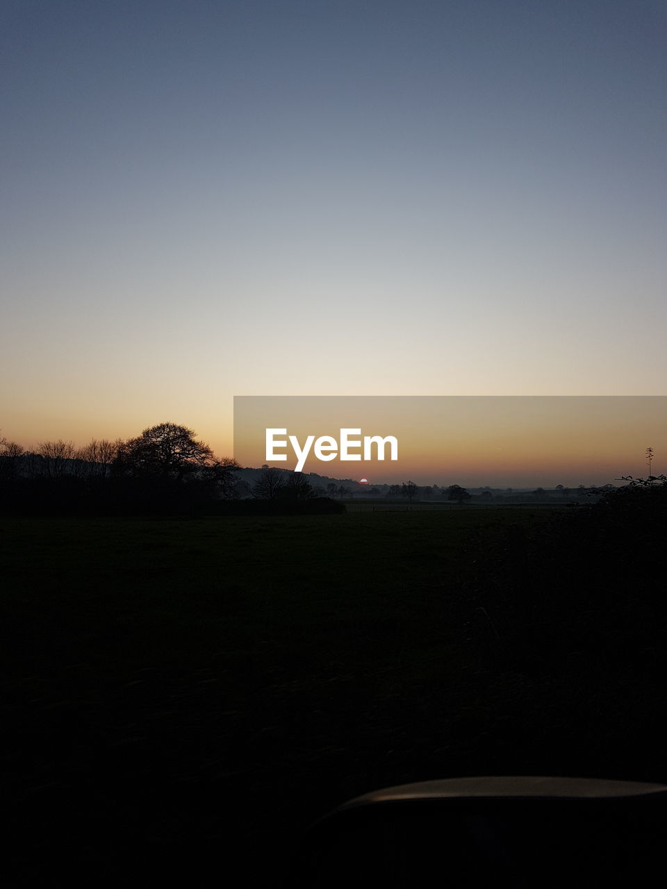 SILHOUETTE LANDSCAPE AGAINST CLEAR SKY DURING SUNSET