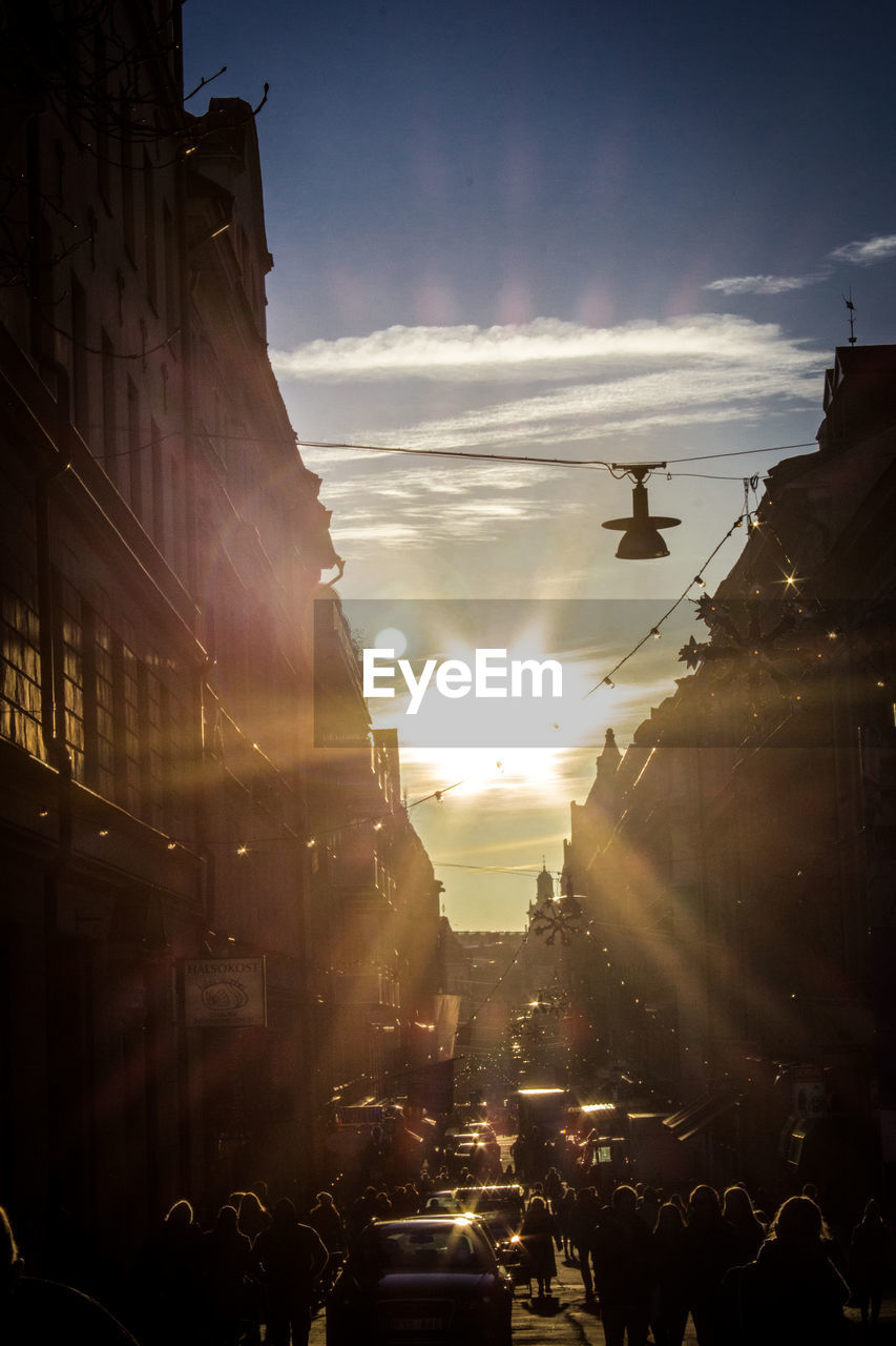 PEOPLE ON STREET IN CITY DURING SUNSET