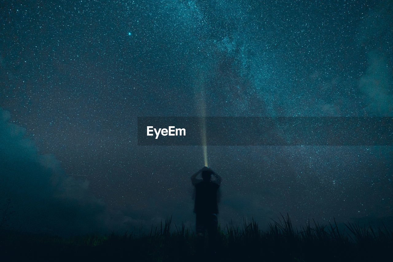 REAR VIEW OF SILHOUETTE PERSON STANDING AGAINST SKY