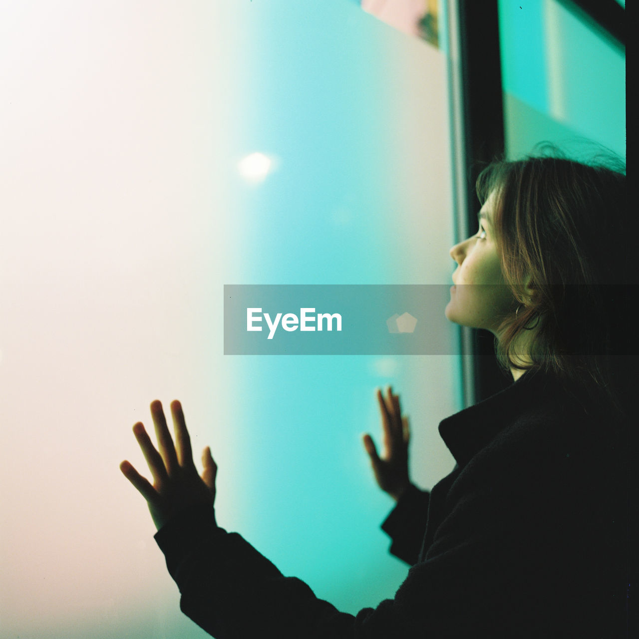 Young woman standing by window