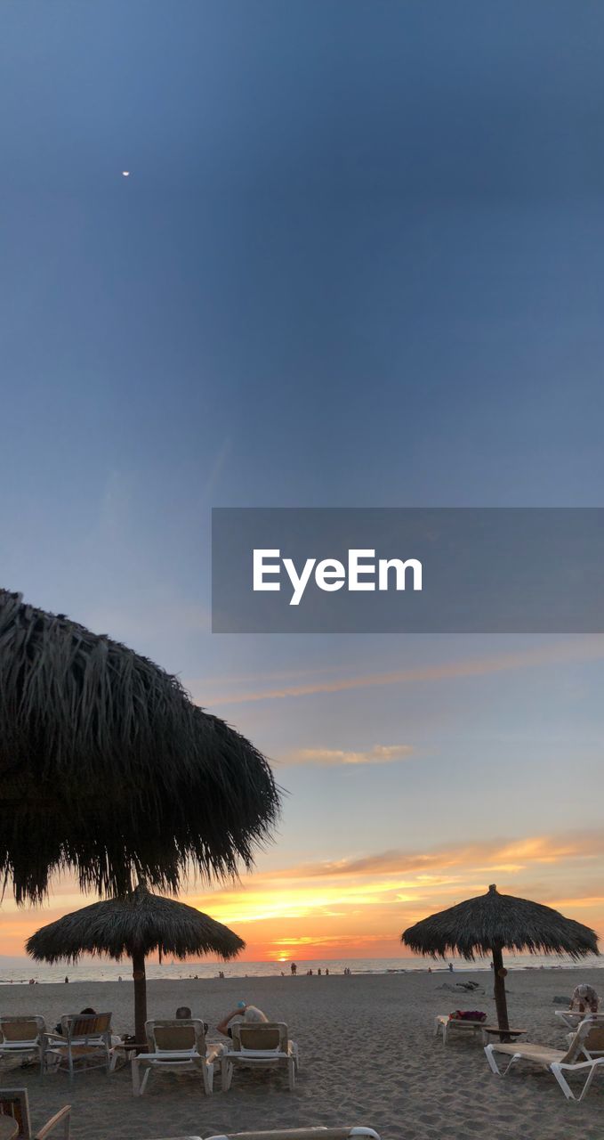 Scenic view of beach against sky during sunset