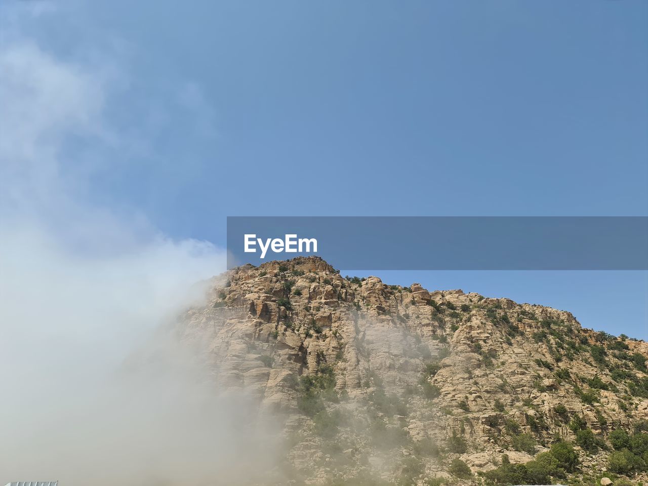 Low angle view of rock formation against sky