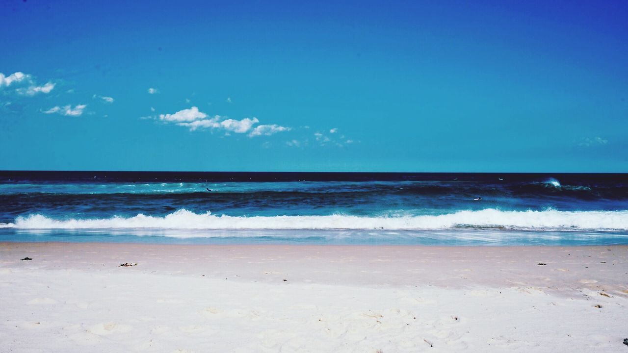 VIEW OF BEACH AGAINST BLUE SKY