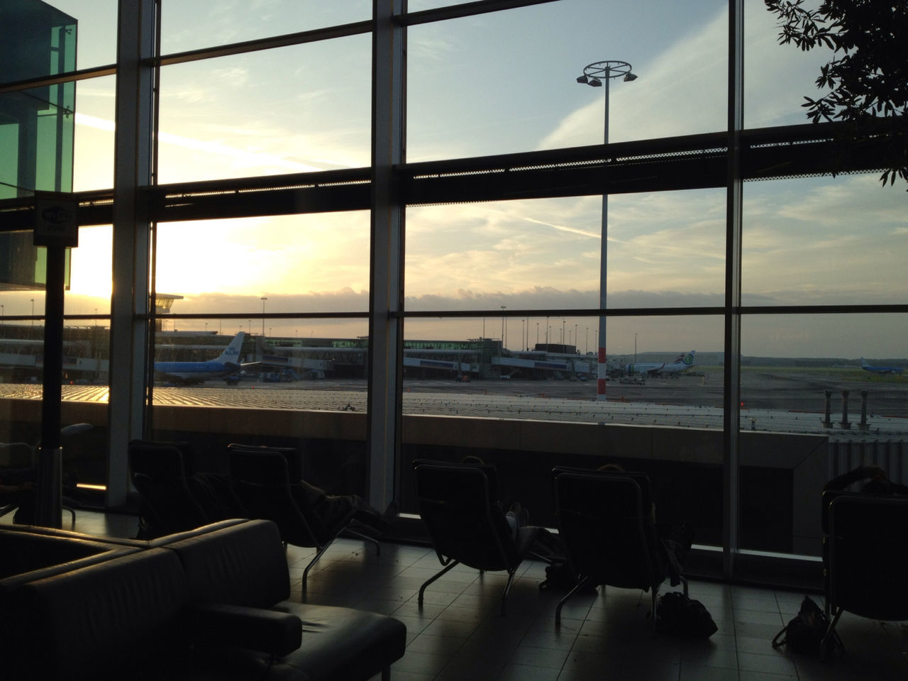 Seats in an airport lobby with runway view