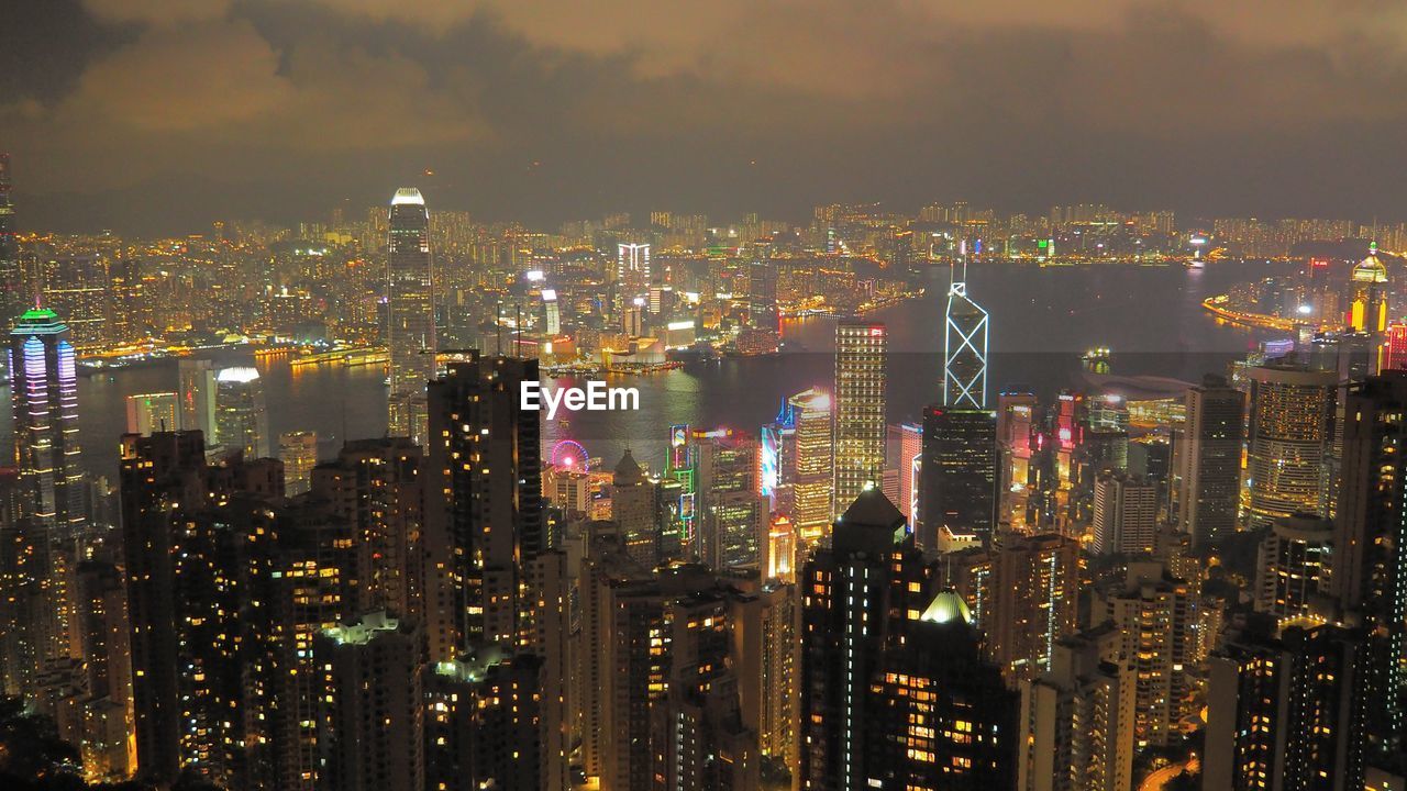 Illuminated cityscape against sky at night