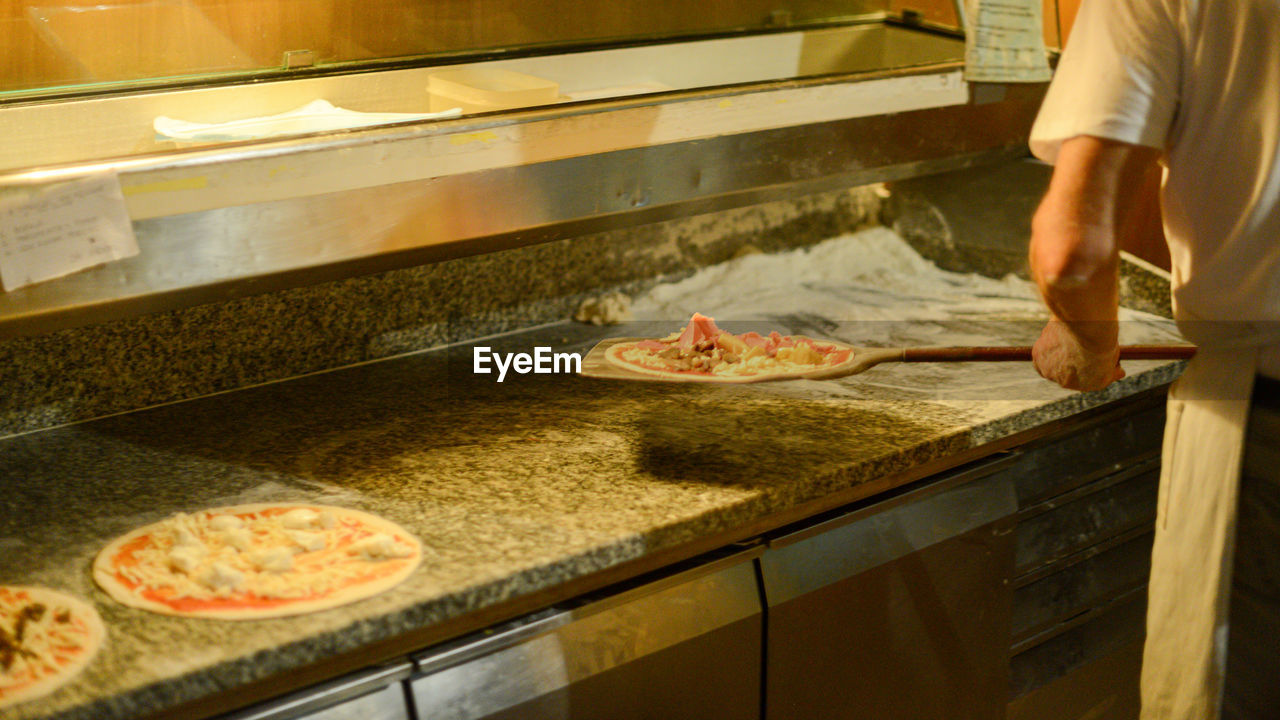 Preparing and cooking pizza in the wood copper oven