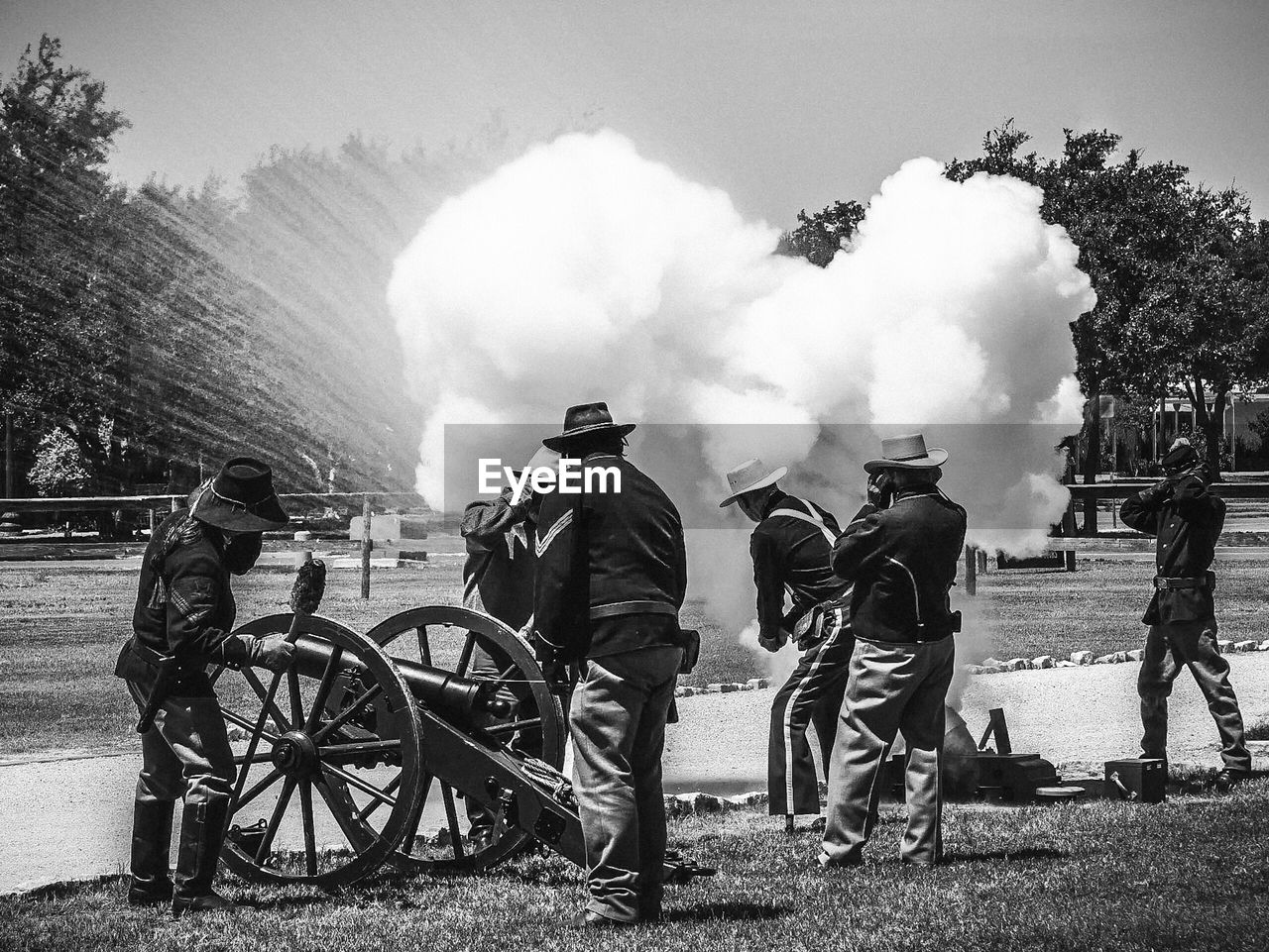 Full length on men standing by smoke at war