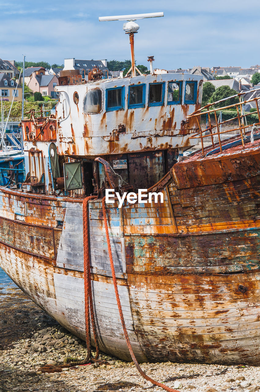 ABANDONED BOAT ON SHORE