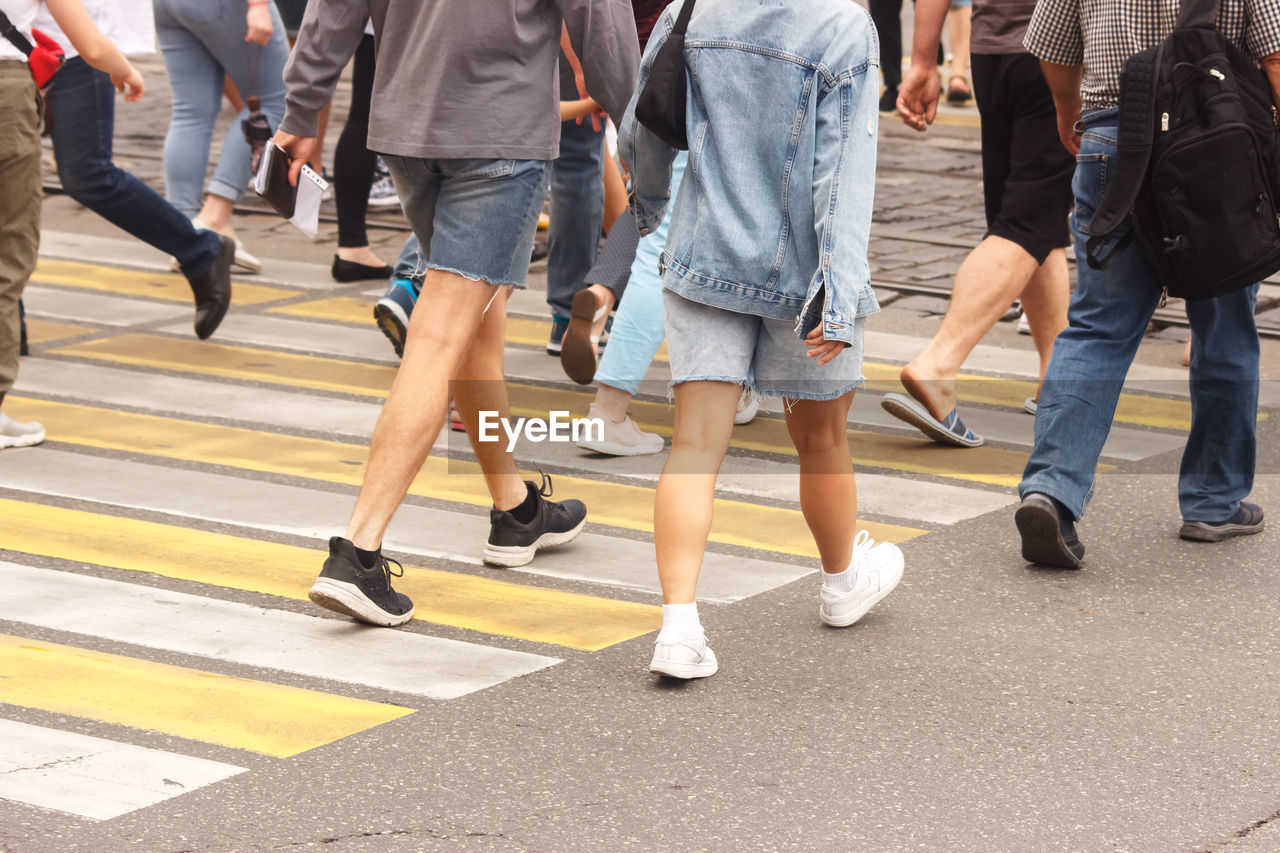 LOW SECTION OF WOMEN WALKING ON ROAD