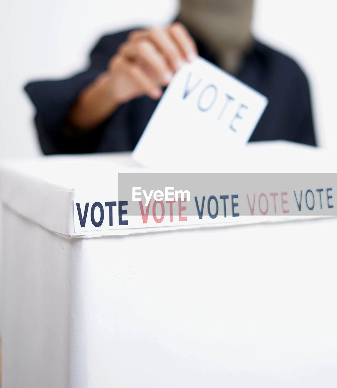 Girl inserting a ballot into a ballot box