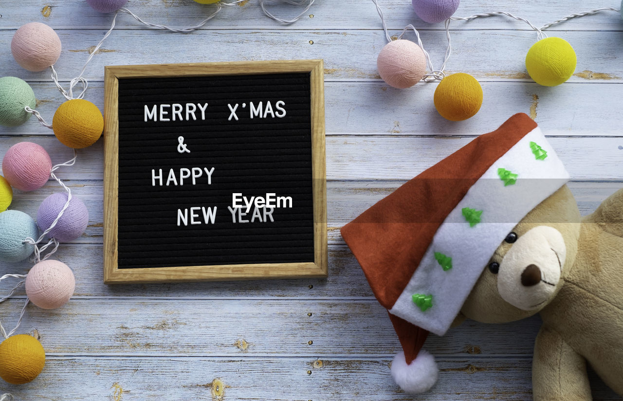 High angle view of information sign say merry christmas and happy new year on table