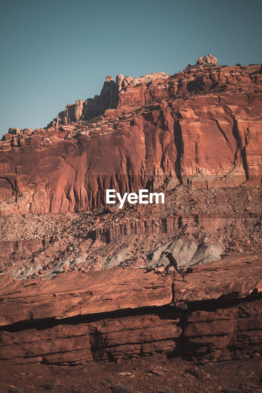 VIEW OF ROCK FORMATION AGAINST MOUNTAIN