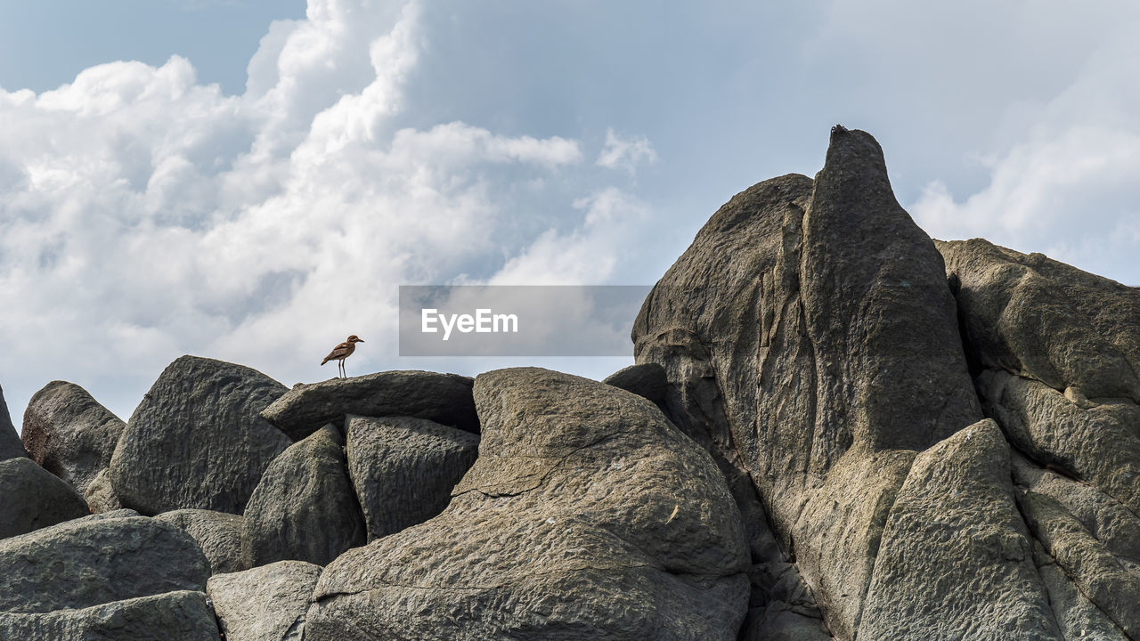 LOW ANGLE VIEW OF ROCK FORMATIONS ON LAND AGAINST SKY