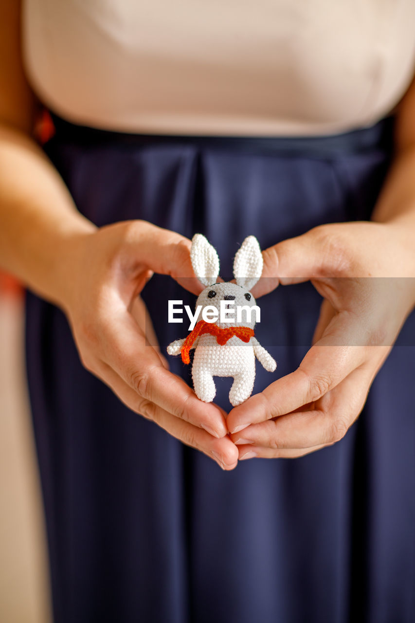 midsection of woman holding christmas present