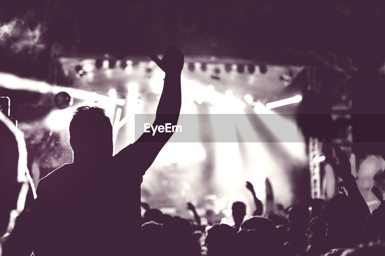 Crowd enjoying in music festival at night