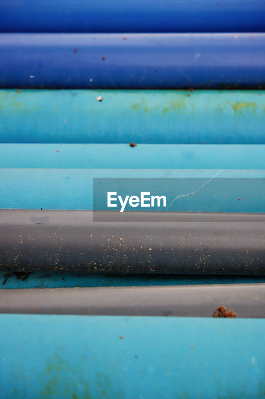 In A Row Red Stack Tube Backgrounds Blue Building Site Close-up Colorful Cover Covering Day Full Frame Material No People Outdoors Pipe Pipe - Tube Pipes Stacked Stuff