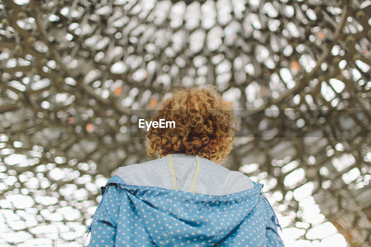 Rear view of young woman standing in gazebo