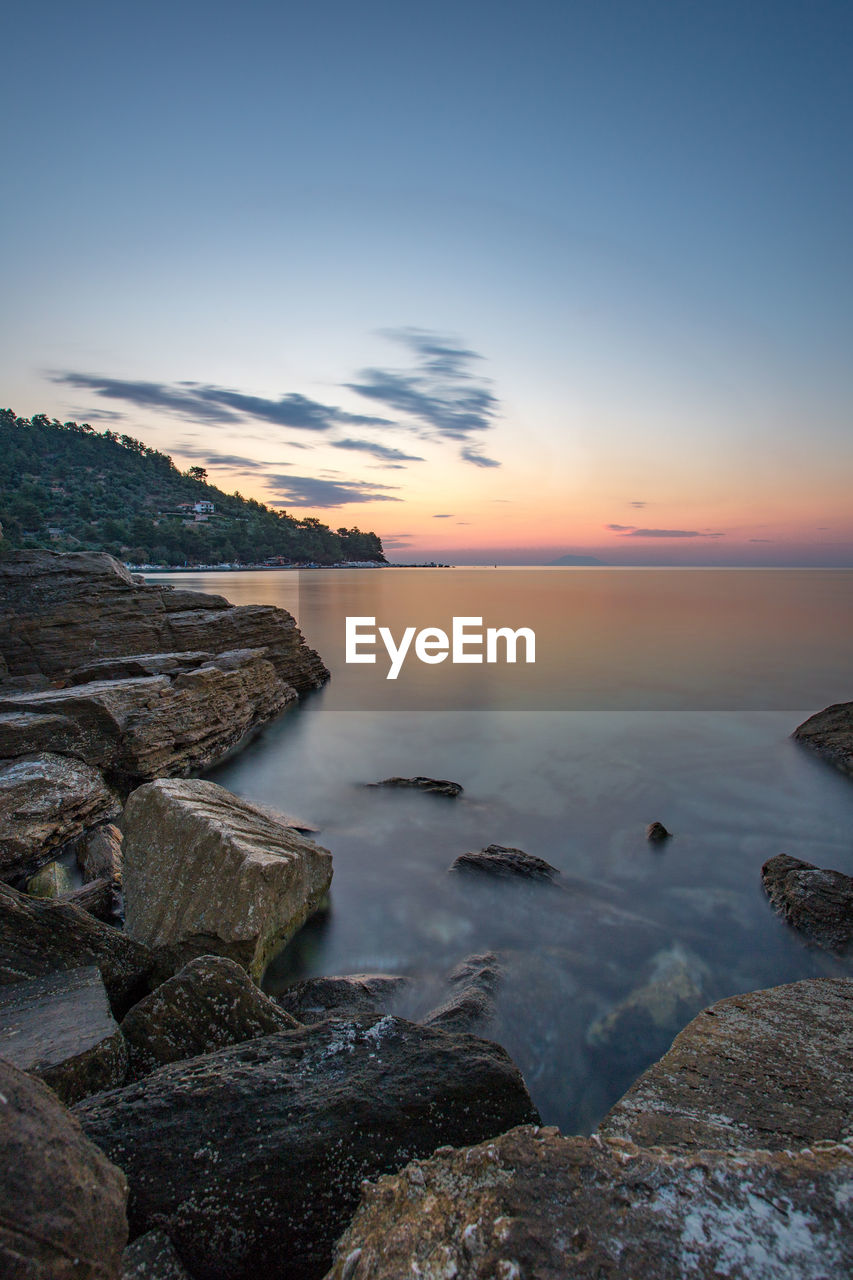 Scenic view of sea against sky at sunset