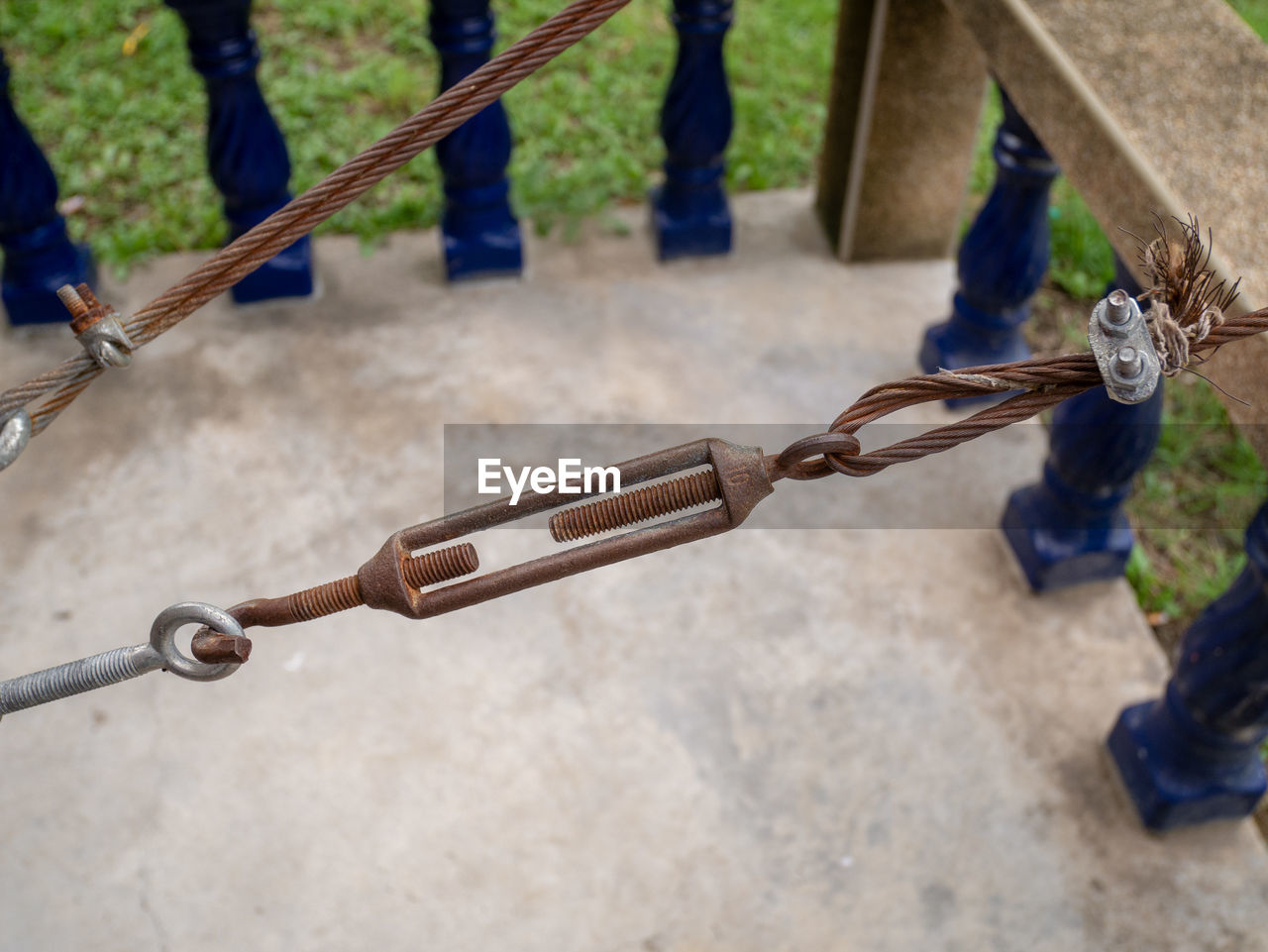 HIGH ANGLE VIEW OF CHAIN SWING ON PLAYGROUND