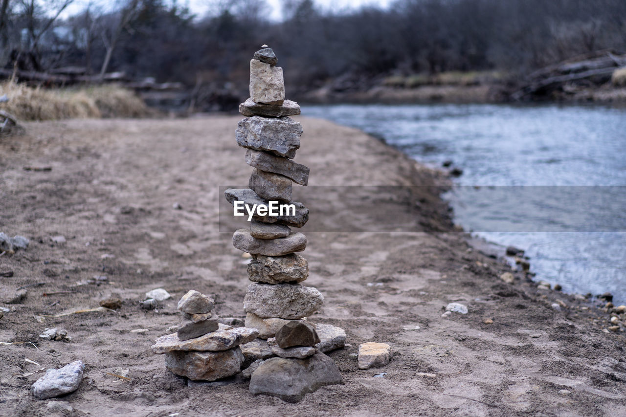 STACK OF STONES ON FIELD