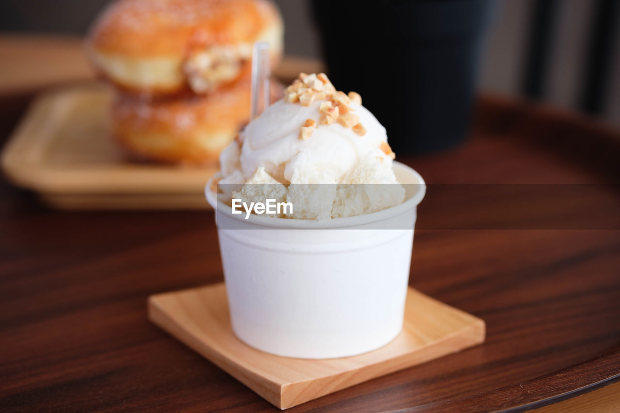 Close-up of ice cream in cup on table