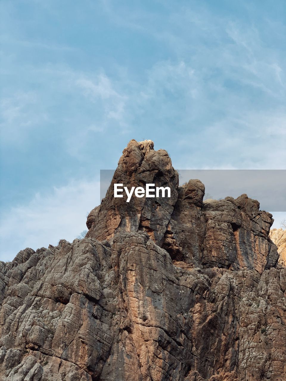 Low angle view of rock formation against sky