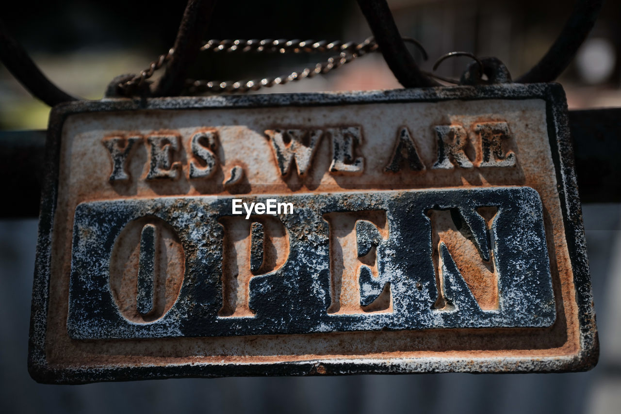 CLOSE-UP OF TEXT ON OLD RUSTY METAL