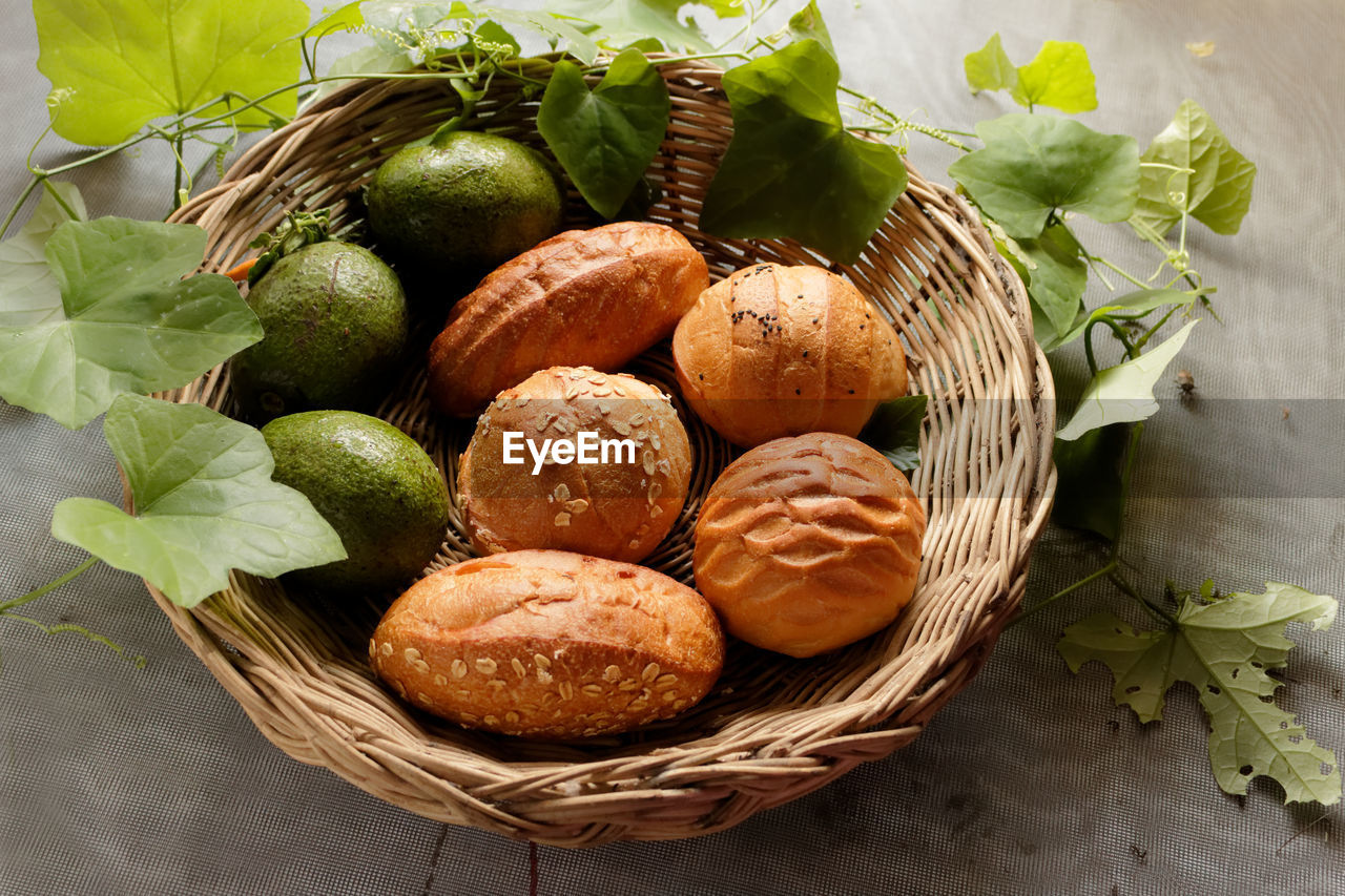 Bread and avocado in basket decorate by gourd leaf