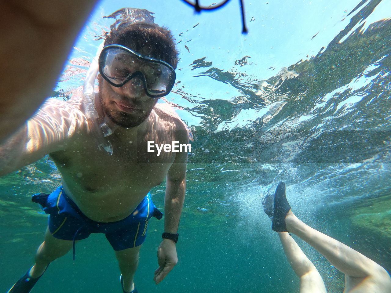 PEOPLE SWIMMING IN SEA