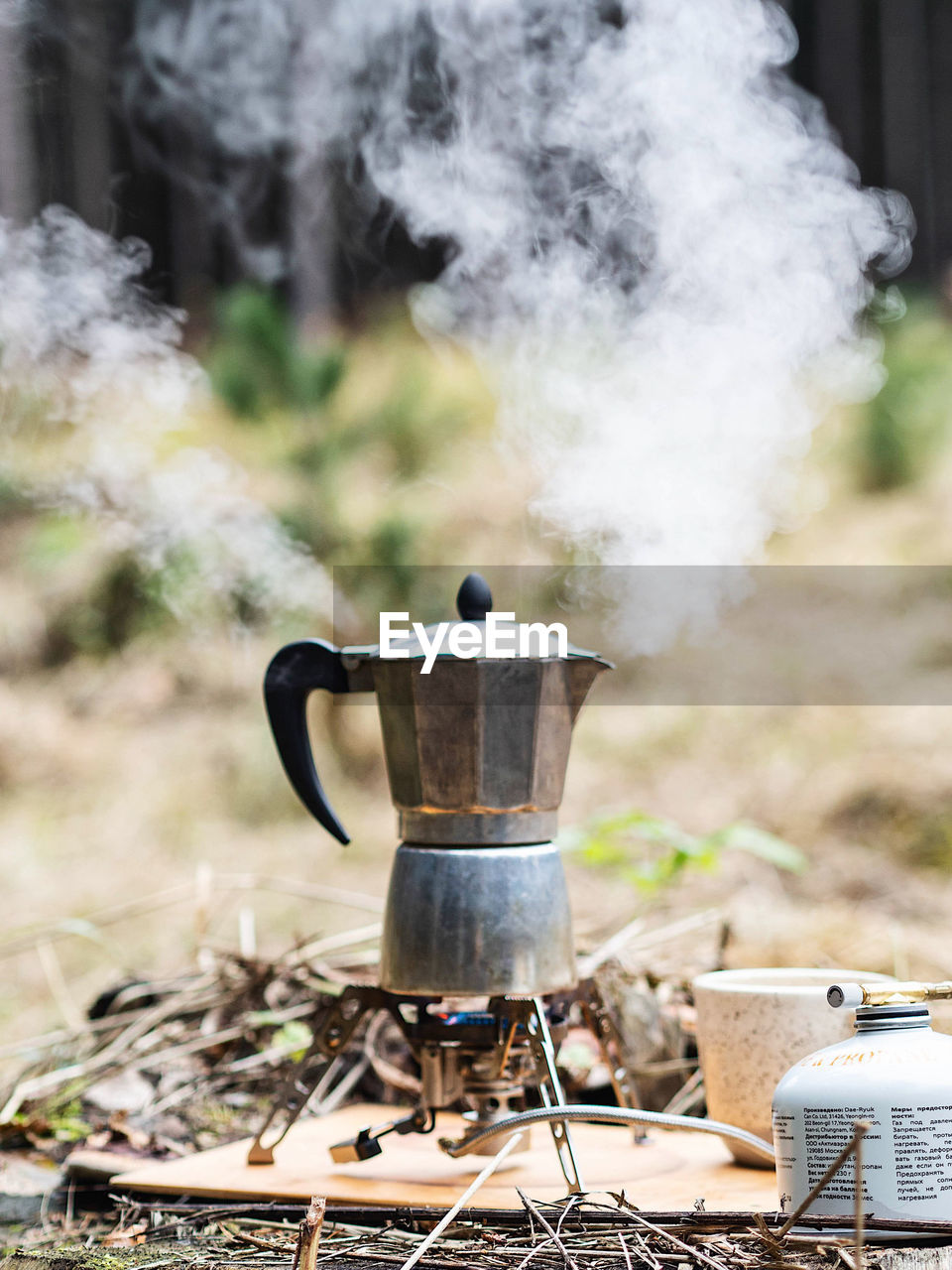 Making coffee outdoors in a metal coffee pot