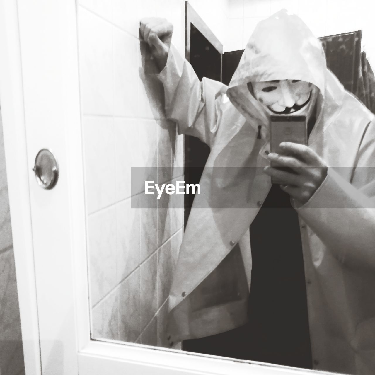 one person, adult, black and white, men, hygiene, white, protection, indoors, bathroom, reflection, mirror, occupation, security, monochrome photography, holding, monochrome, clothing, protective workwear, waist up, obscured face
