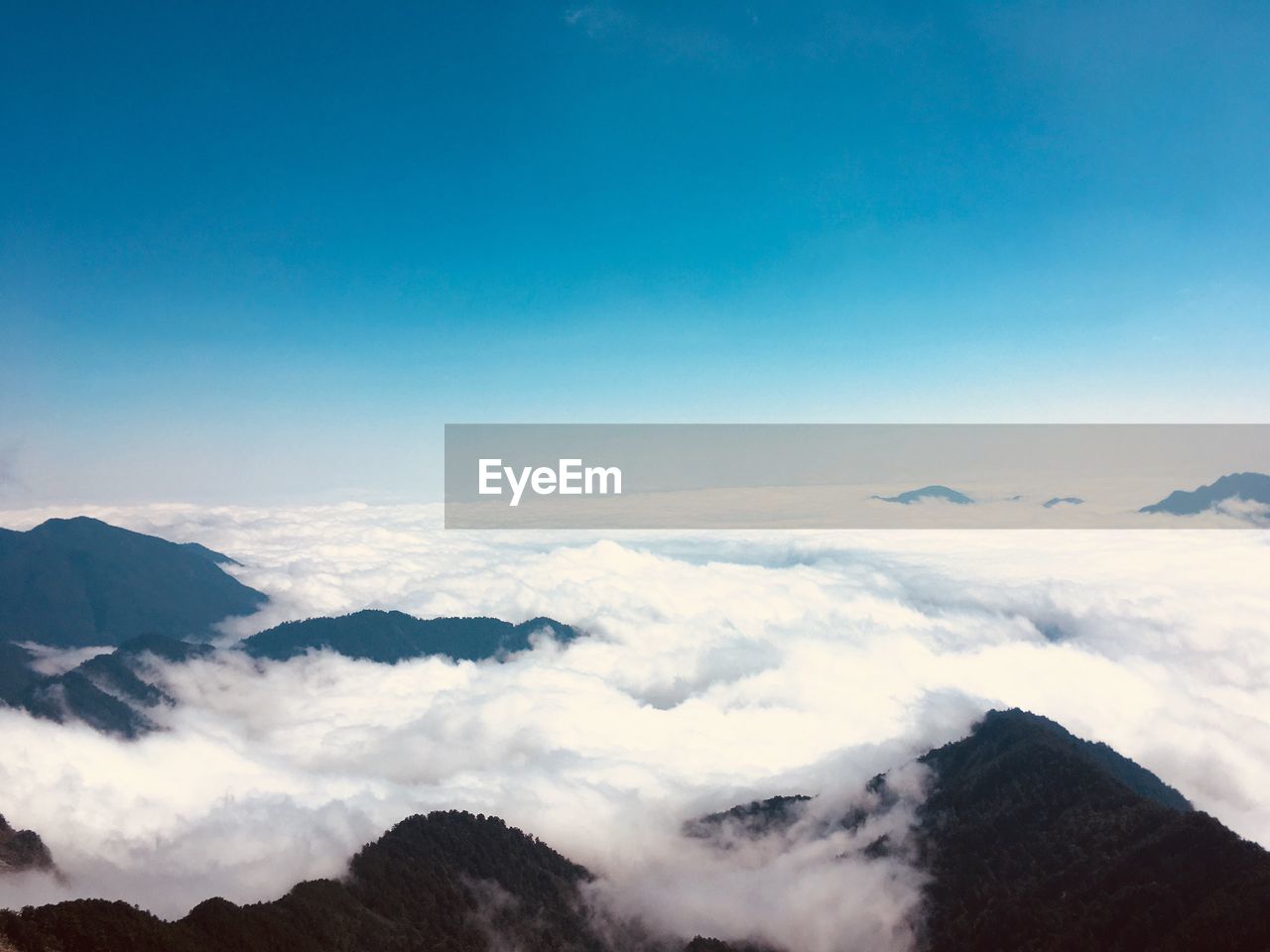 Scenic view of mountains against blue sky