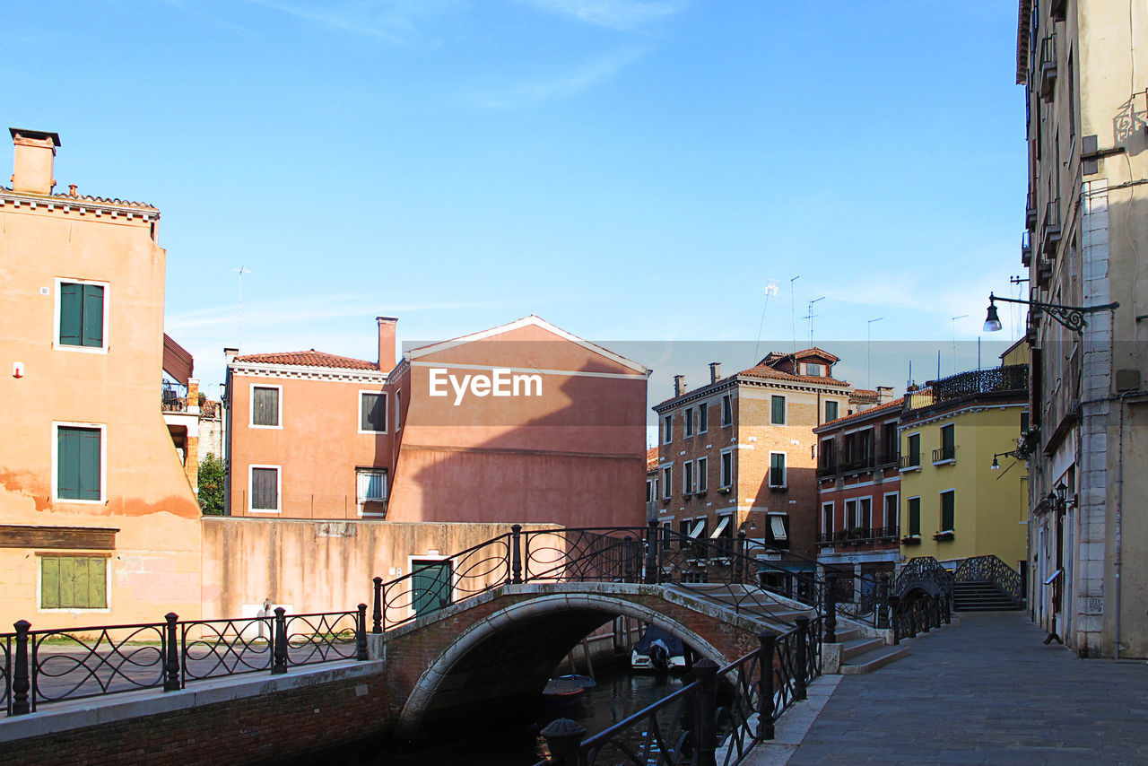 CANAL AMIDST BUILDINGS AGAINST SKY IN CITY