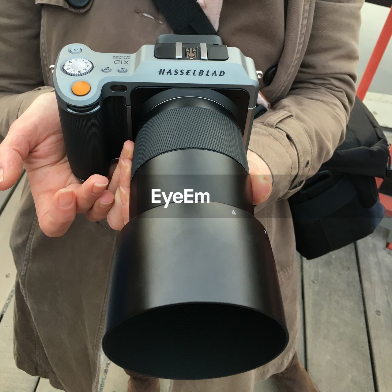 CLOSE-UP OF A PERSON HOLDING CAMERA