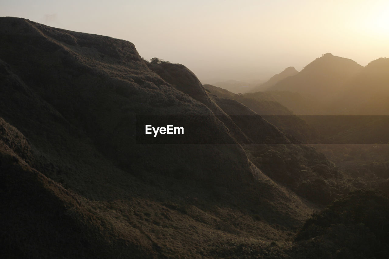 Scenic view of mountains against clear sky during sunset