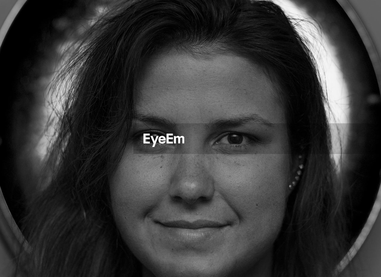 Close-up portrait of smiling young woman