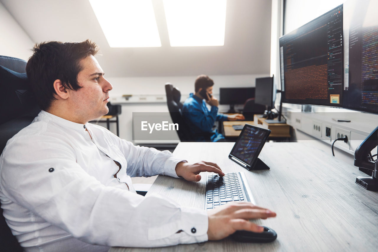 midsection of businessman working at desk in office