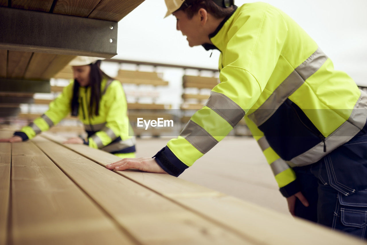 Female workers examining planks at lumber industry