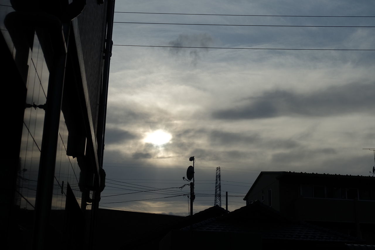 High section of silhouette built structure against clouds