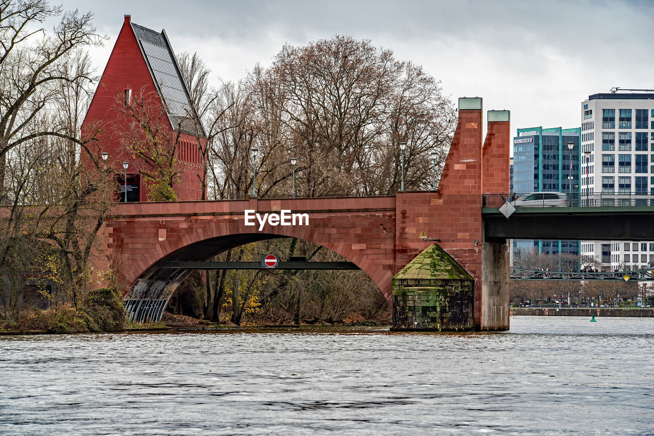 architecture, built structure, building exterior, river, water, building, city, waterway, sky, nature, tree, bridge, urban area, cityscape, bare tree, cloud, winter, no people, reflection, travel destinations, landmark, plant, landscape, history, outdoors, the past, travel, waterfront, day, transportation