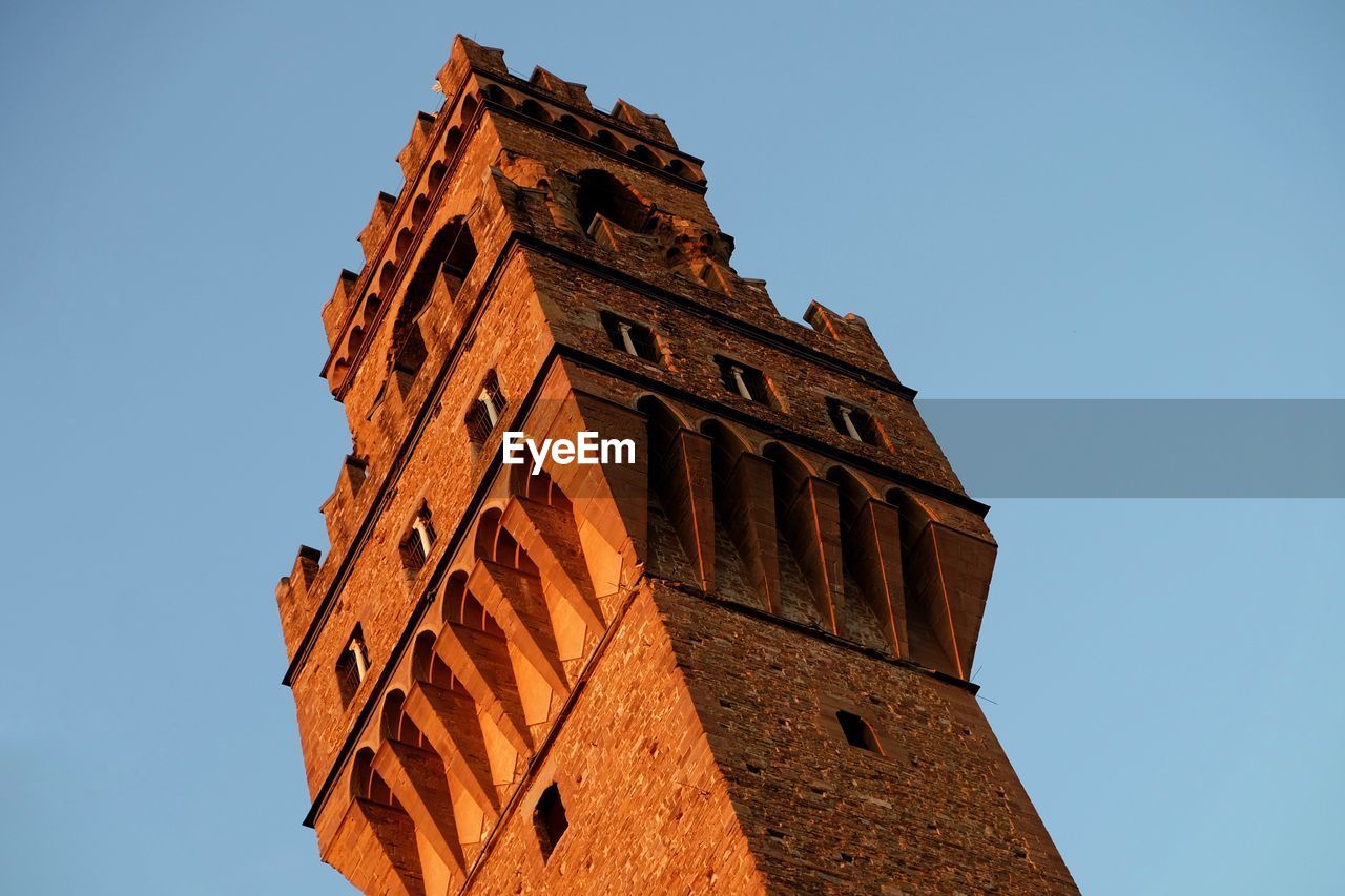 Low angle view of historical building against clear blue sky