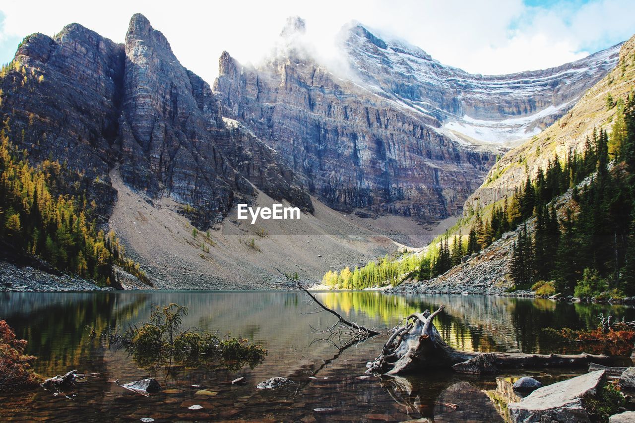 Scenic view of lake and mountains against sky