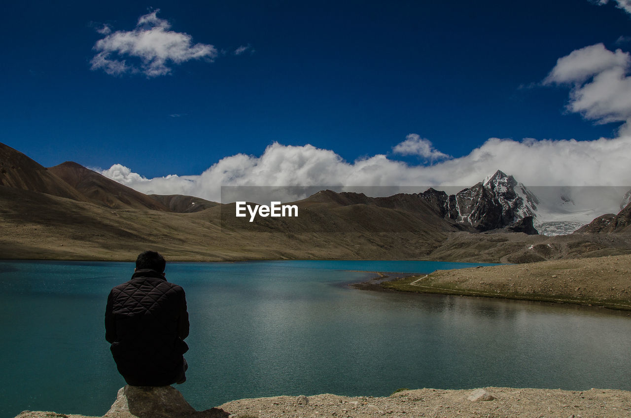 Rear view of man standing in lake